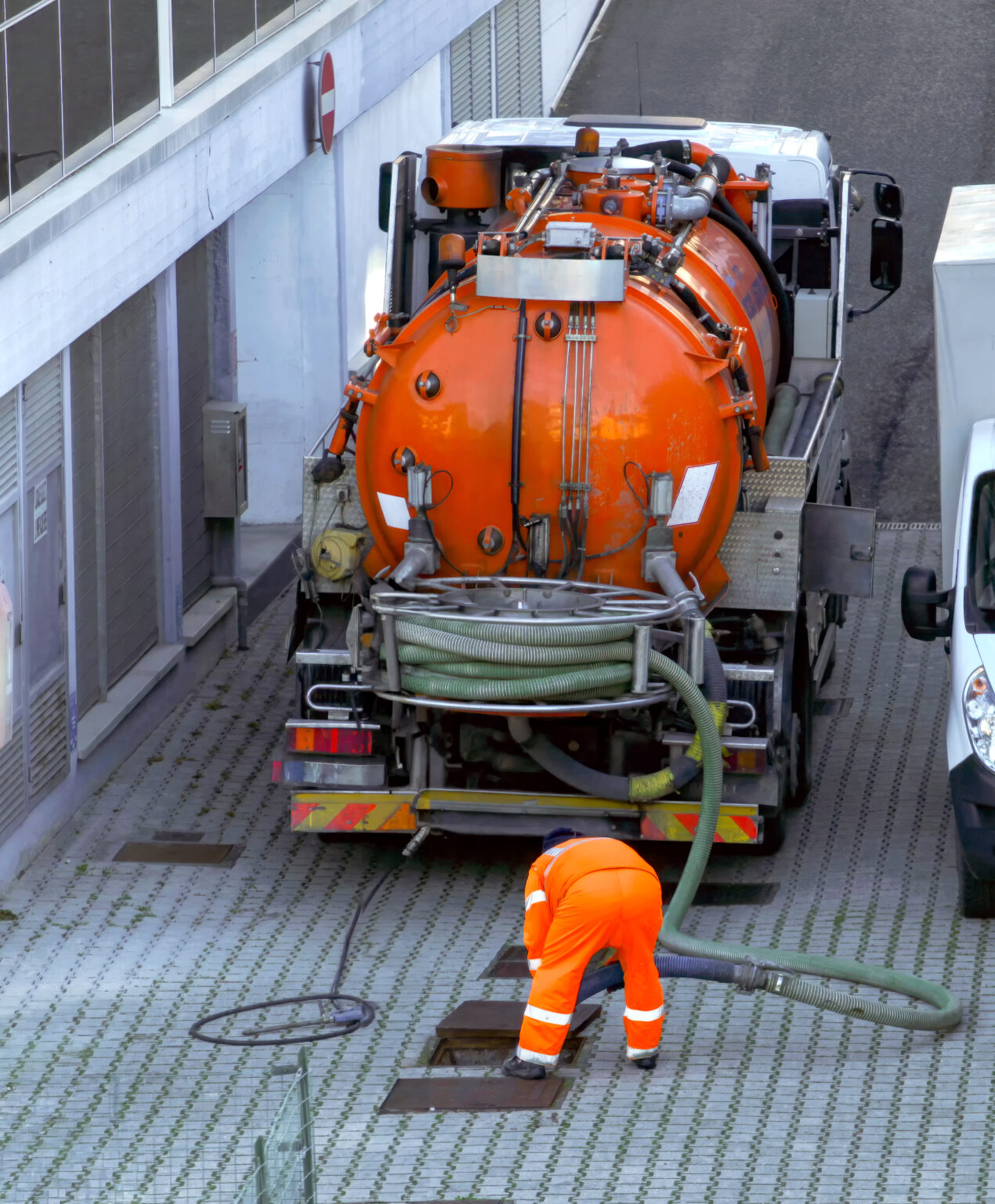 worker lowers sewer hose into sewer pit 2025 03 23 20 08 33 utc